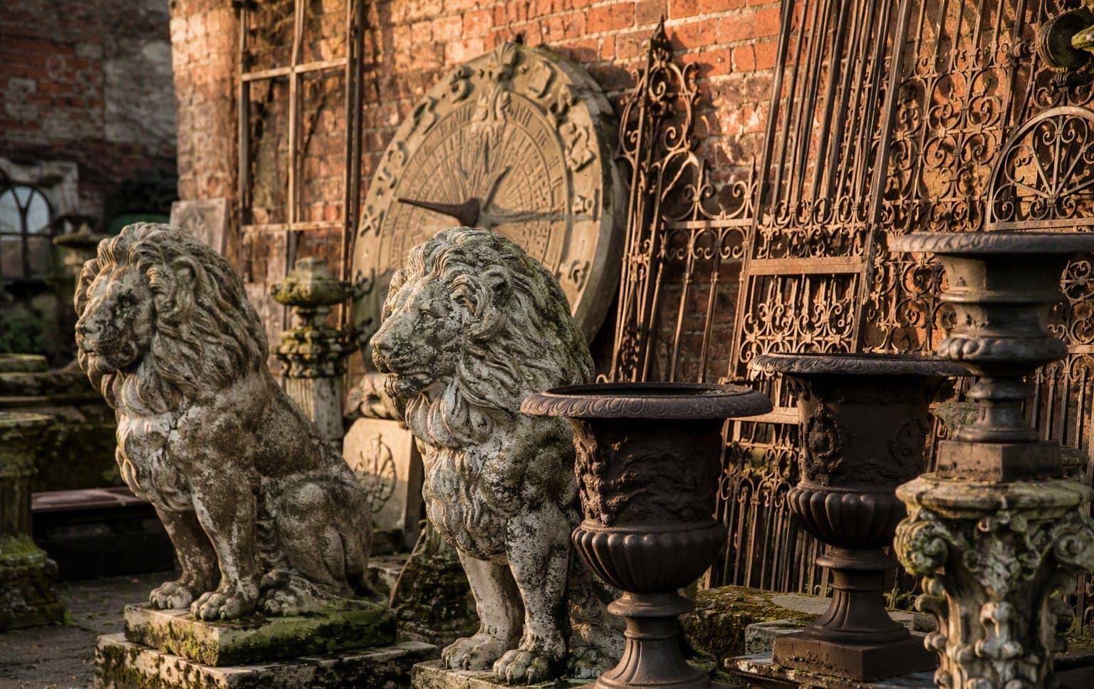 Weathered stone lions and wrought iron gates in the yard